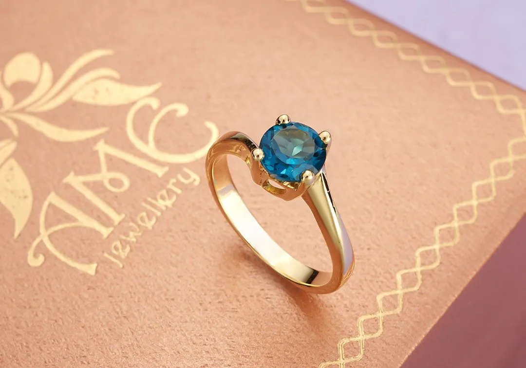 6mm Blue Topaz twist Ring in 14K Yellow Gold