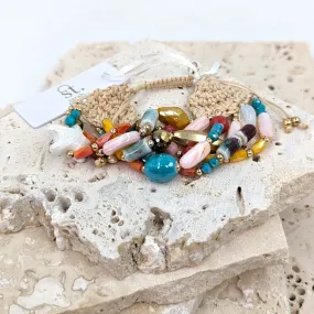 Multi beaded bracelet with woven cord finishing and little star element